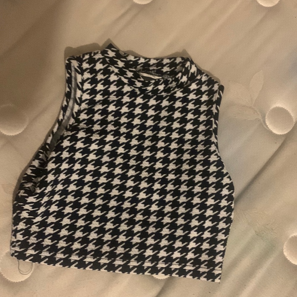 It has a unique pattern and it’s a turtle neck and it’s sleeveless